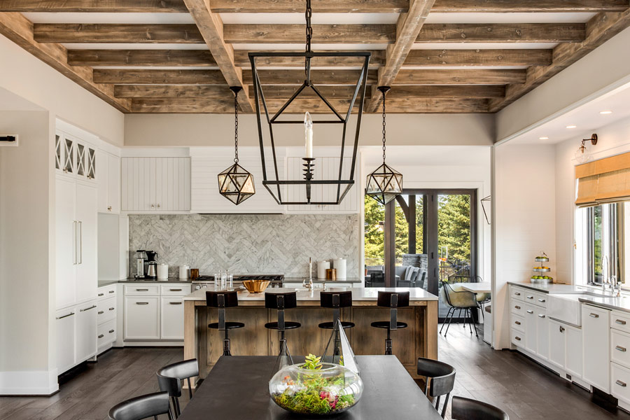 contemporary white kitchen with soft wood and modern lighting